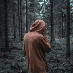 hooded youth in a forest