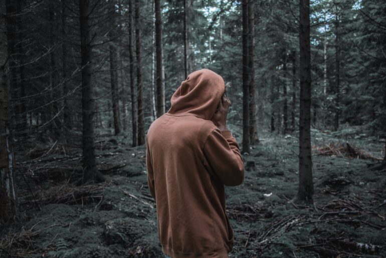 hooded youth in a forest